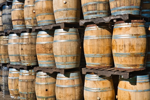 Horizontal shooting of old wooden barrels at a winery.