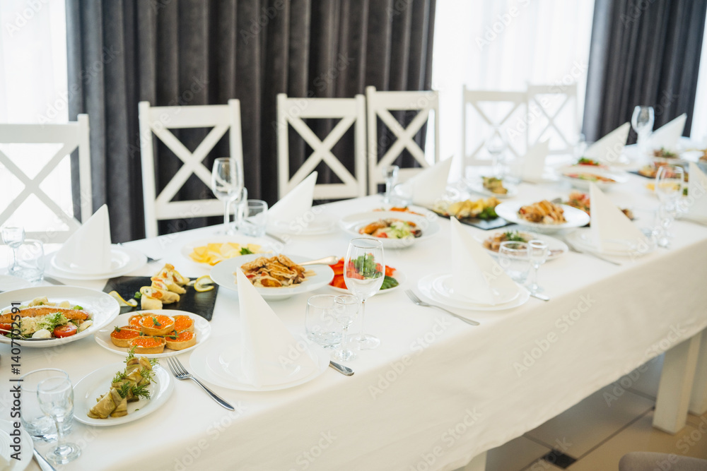 Elegant dining setup with assorted dishes at a banquet venue during daylight