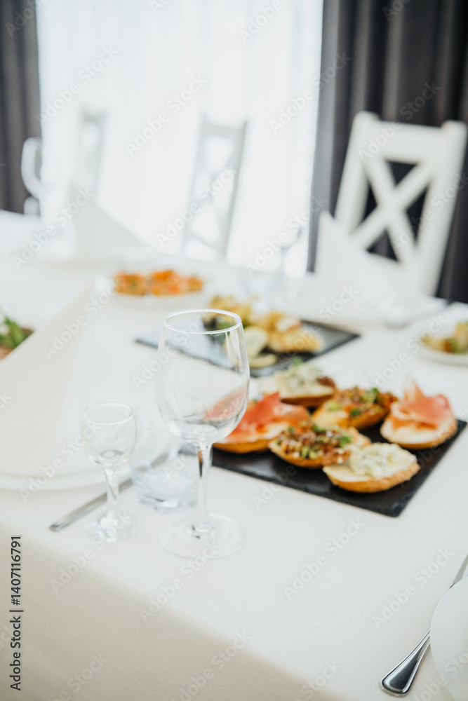 Fototapeta premium Elegant dining setup with appetizers on a table before a gathering