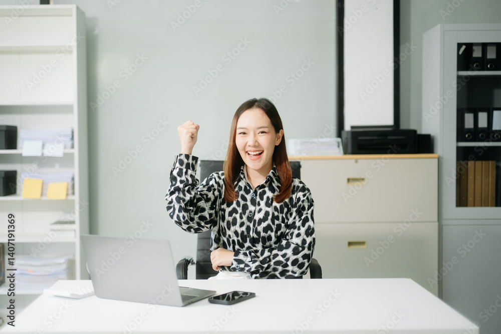 Young Asian businesswoman smiling and working with tablet and laptop in office. Young Asian businesswoman smiling and working with tablet and laptop in office.