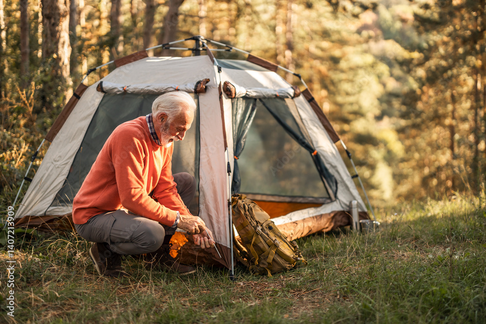 Senior Man Camping in a Forest with Tent Setup
