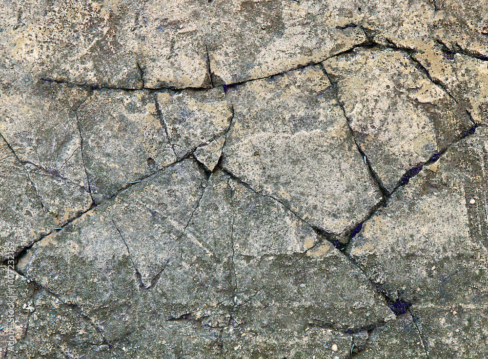 Obraz premium Cracked concrete surface showing signs of age and distress