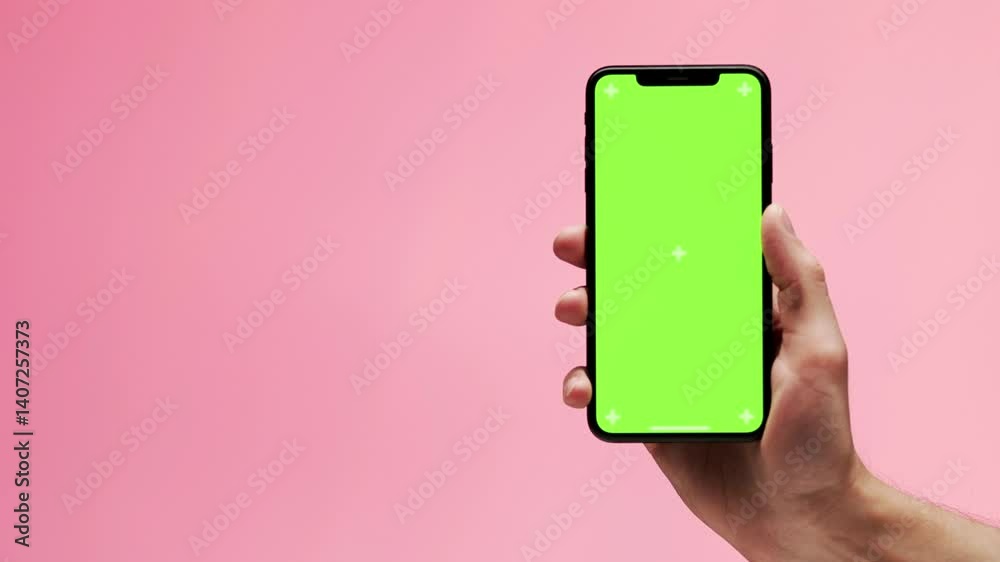 Unrecognizable girl browsing content at green screen smartphone in office close up. Woman hand holding chroma key cellphone watching social media. Unknown businesswoman reading message on mobile phone
