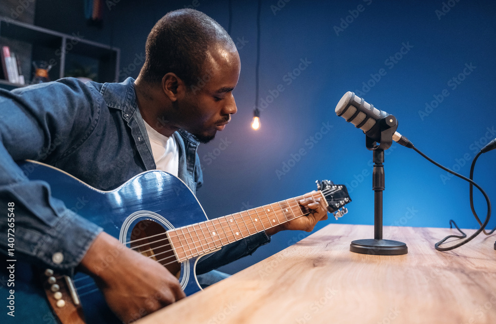 Obraz premium Singer songwriter with guitar. Man is doing podcast in the studio