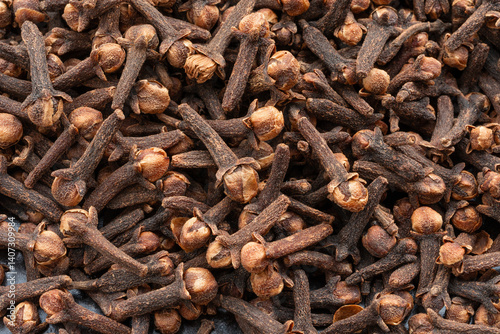 Fototapeta Naklejka Na Ścianę i Meble -  Clove spice textured background. Dry carnation spicy buds pattern, natural Indian clove condiment