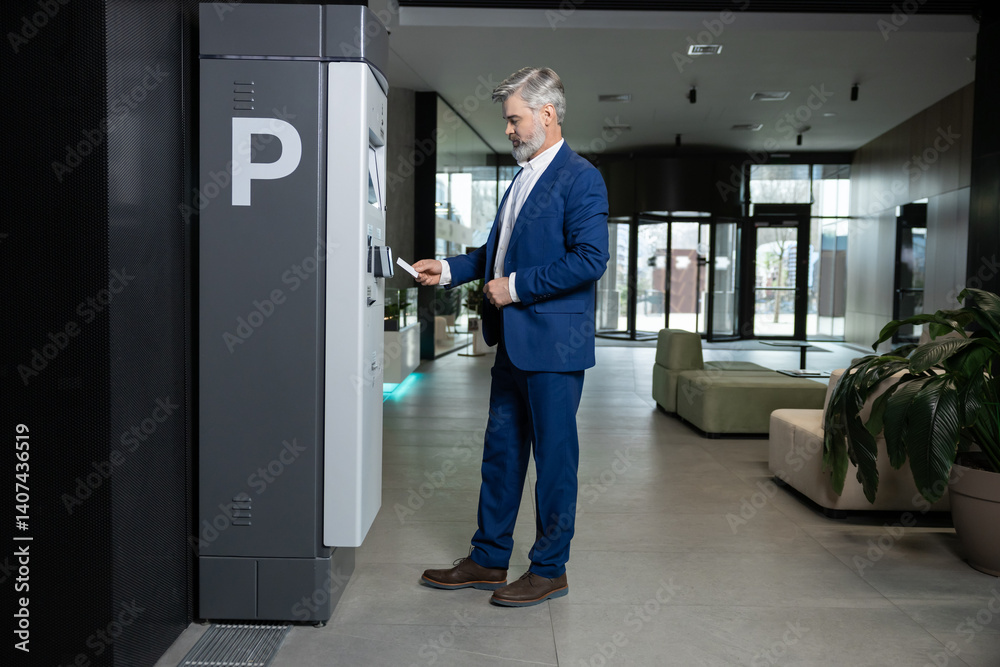 Man paying parking fee using card at automatic machine Man paying parking fee using card at automatic machine