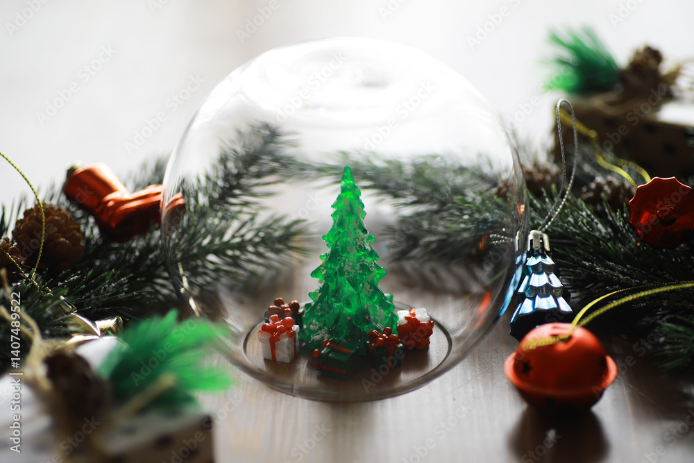 Fototapeta premium Festive Christmas Decorations with Miniature Tree and Gifts under Glass Dome