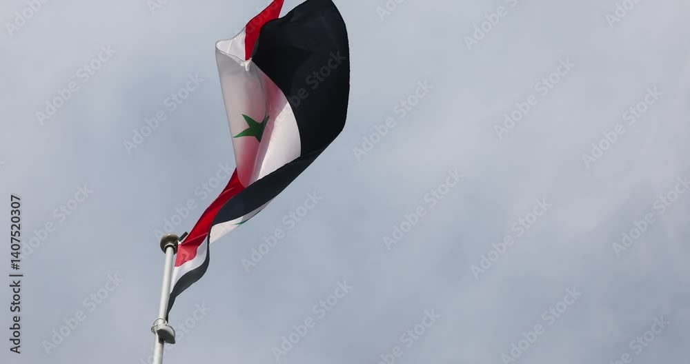 The national flag of the syrian arab republic flutters in the wind. Great for news. Close-up. The flag of the syrian arab republic against the blue sky. 4K video.