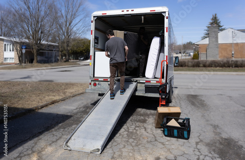 Man moving furniture out of a rental truck
