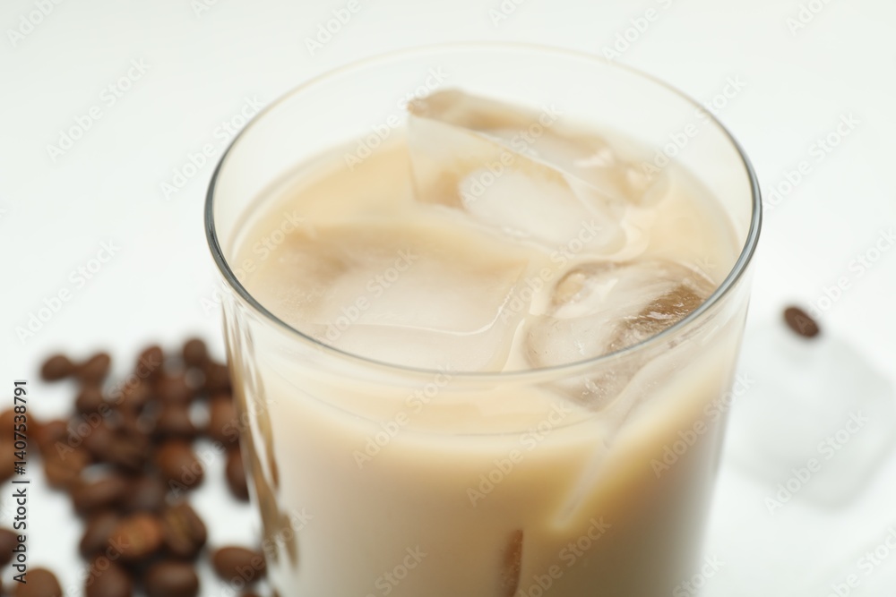 Coffee cream liqueur in glass and beans on white table, closeup Coffee cream liqueur in glass and beans on white table, closeup