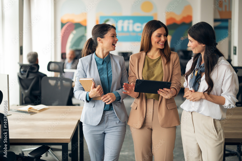 Three Businesswomen Collaborating and Smiling in a Modern Office Space