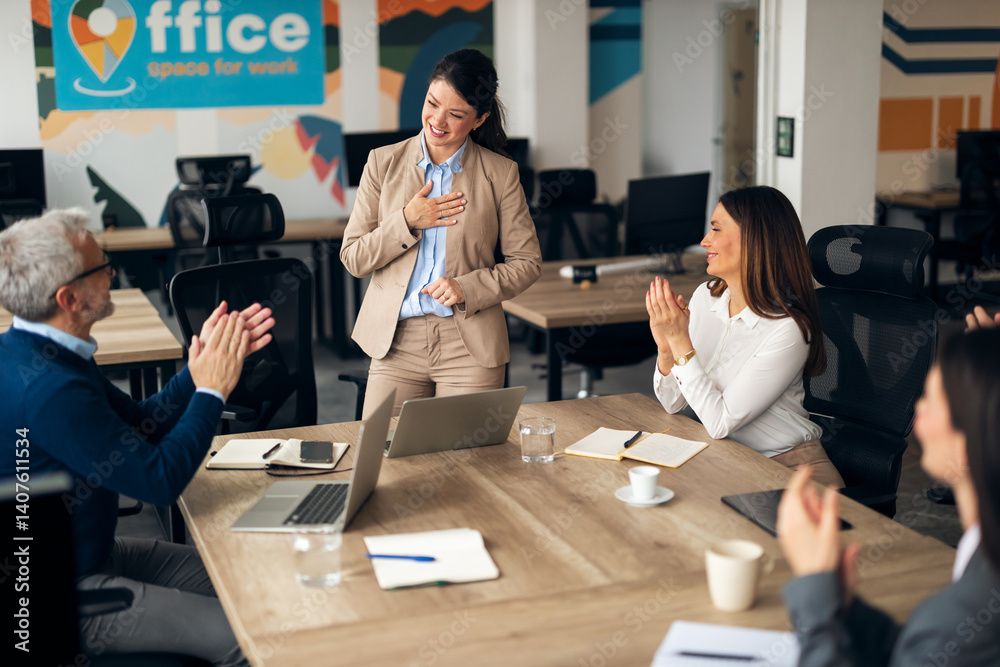 Team Applauding Colleague During Office Meeting in Modern Workspace