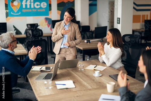 Obraz na płótnie Team Applauding Colleague During Office Meeting in Modern Workspace w salonie