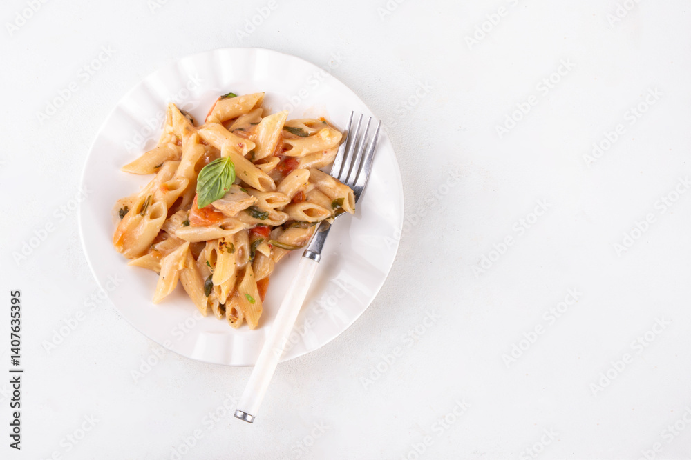 Trendy viral marry me chicken pasta. One pot balanced tender cooked pasta and juicy chicken pieces smothered in creamy and cheesy, garlic sun-dried tomato sauce, wit basil leaves, in plate and pot Trendy viral marry me chicken pasta. One pot balanced tender cooked pasta and juicy chicken pieces smothered in creamy and cheesy, garlic sun-dried tomato sauce, wit basil leaves, in plate and pot