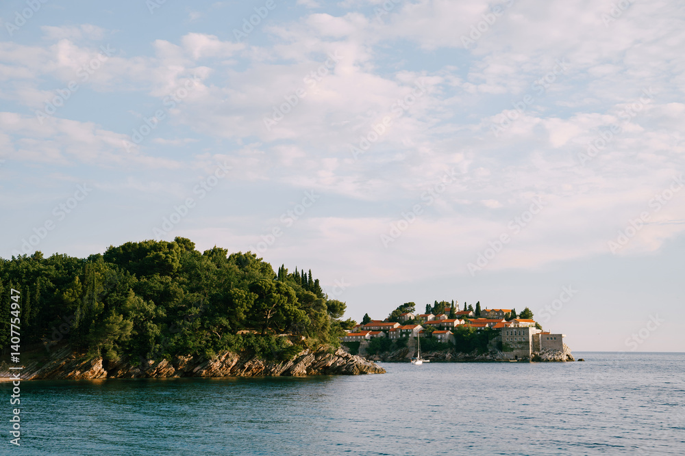 Island of Sveti Stefan protrudes from the rocky shore. Montenegro Island of Sveti Stefan protrudes from the rocky shore. Montenegro