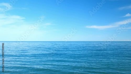 Nature blue background with wavy sea ripples on water surface and cloudy sunny sky. Scenery seascape horizon light. Wild ocean coastline, tourism, place for rest relax on vacation, journey, trip.