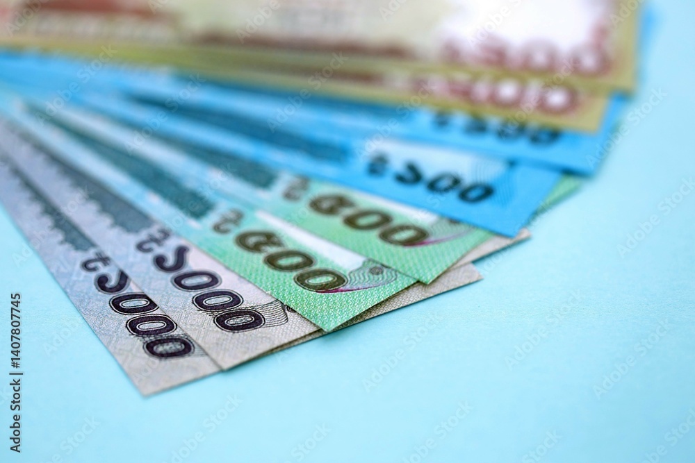 Bangladeshi taka money bills in big amount lies on teal color table close up Bangladeshi taka money bills in big amount lies on teal color table close up