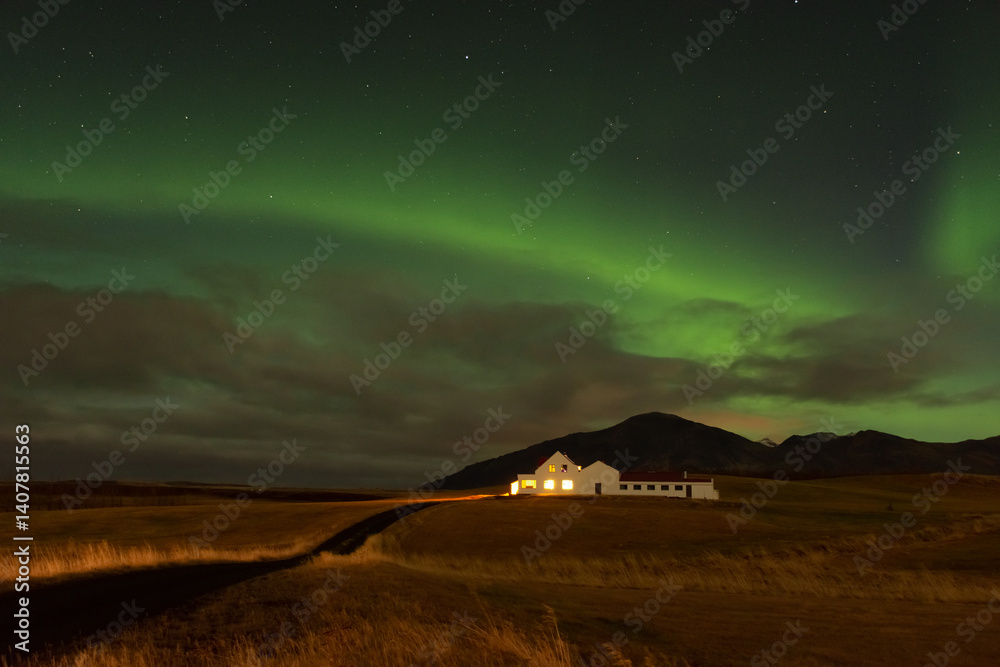 Amazing northern lights with starry sky. Aurora borealis over a lonely house in Iceland
