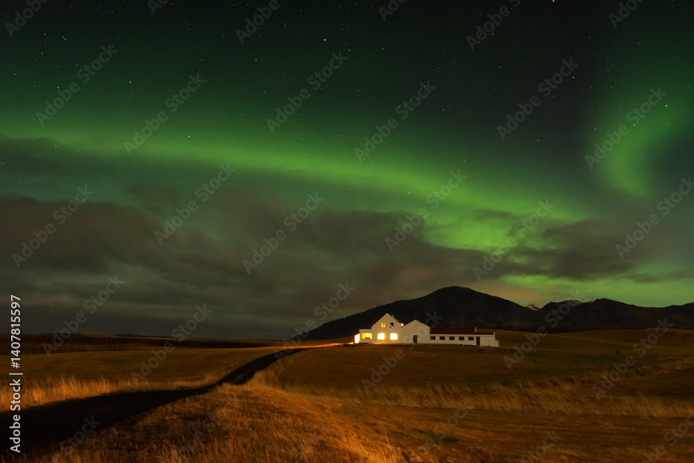 Amazing northern lights with starry sky. Aurora borealis over a lonely house in Iceland