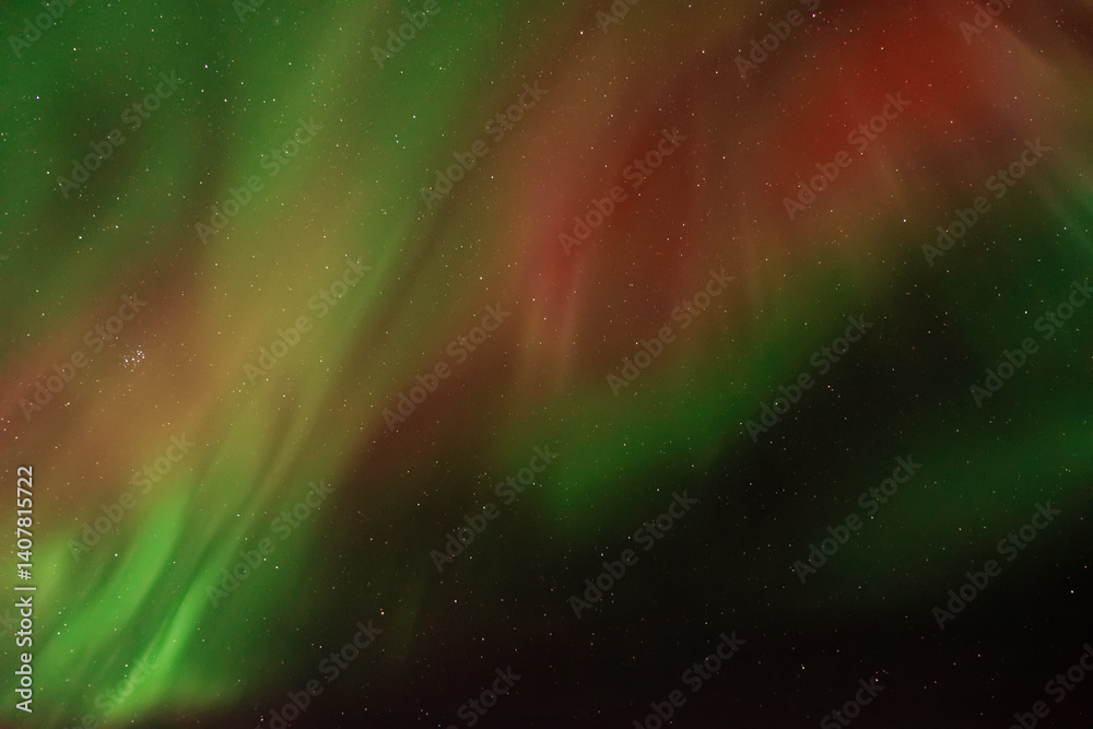 Amazing aurora borealis in the starry sky. Green and red northern lights in Iceland