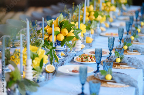 Elegant Dining Table Decorated with Lemons and Blue Accents for Special Occasion