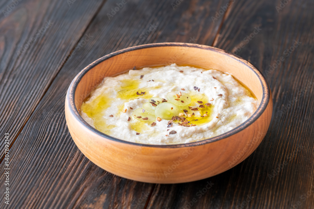 Creamy baba ghanoush in wooden bowl with chili and olive oil Creamy baba ghanoush in wooden bowl with chili and olive oil
