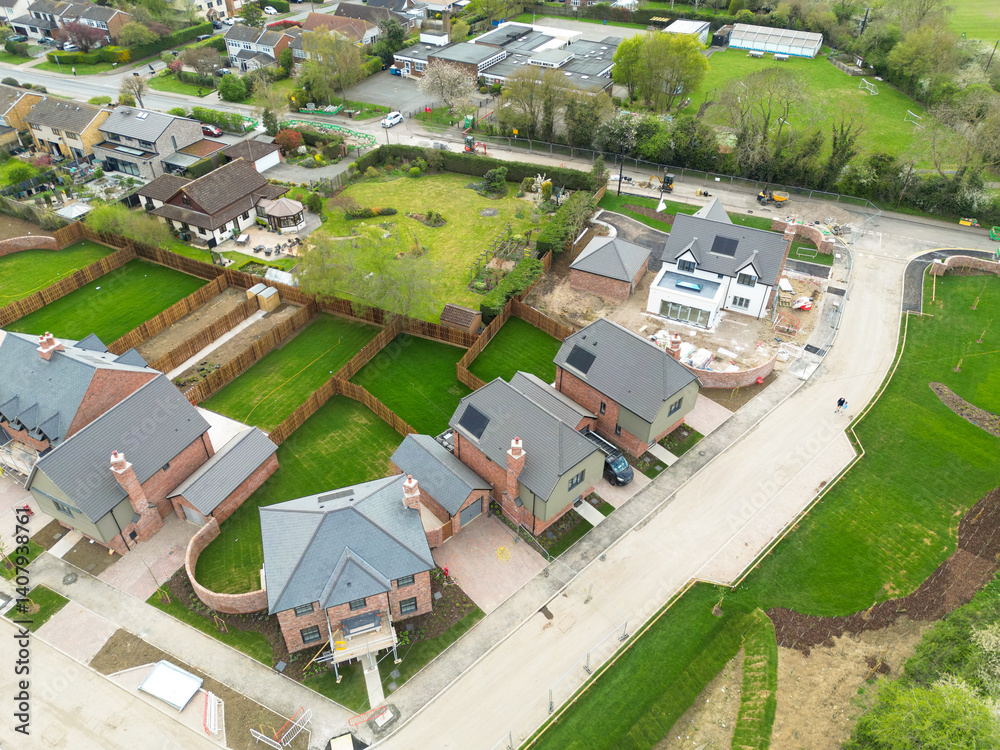 Aerial view of partially completed private, detached executive homes in rural Essex, UK. Other homes comprise of affordable homes and earlier stages of completion.
