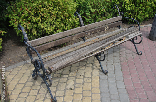 a park bench damaged by hooligans. a broken bench is an example of hooliganism and vandalism
