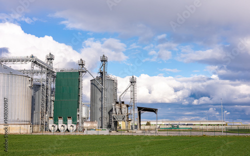 Silver silos on agro-processing and manufacturing plant for processing drying cleaning and storage of agricultural products, flour, cereals and grain. Granary elevator. photo