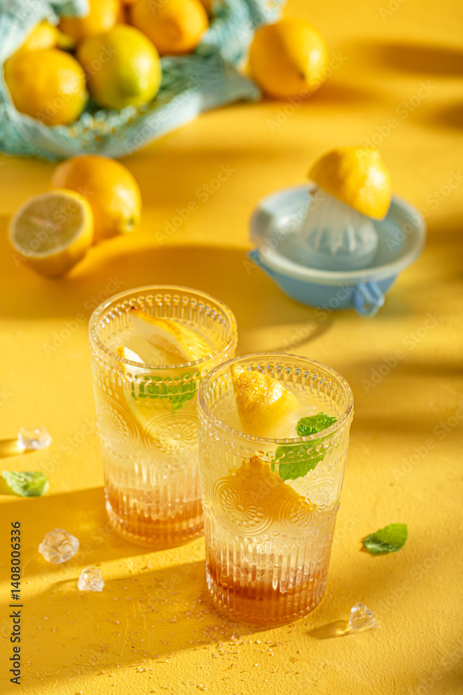 Cold lemonade or mojito cocktail with citrus and mint.