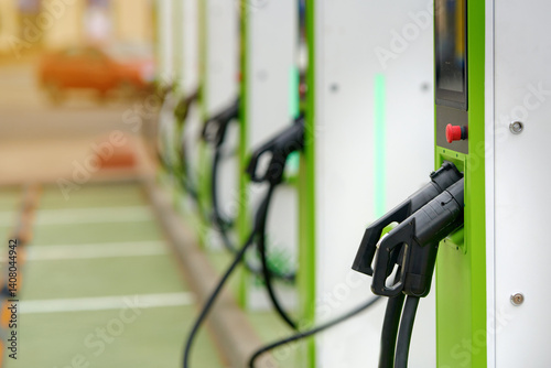 Obraz na płótnie Close-up of charging station connector plug. Car charging station, plug and connector details in an urban environment. Electric car charger. w salonie