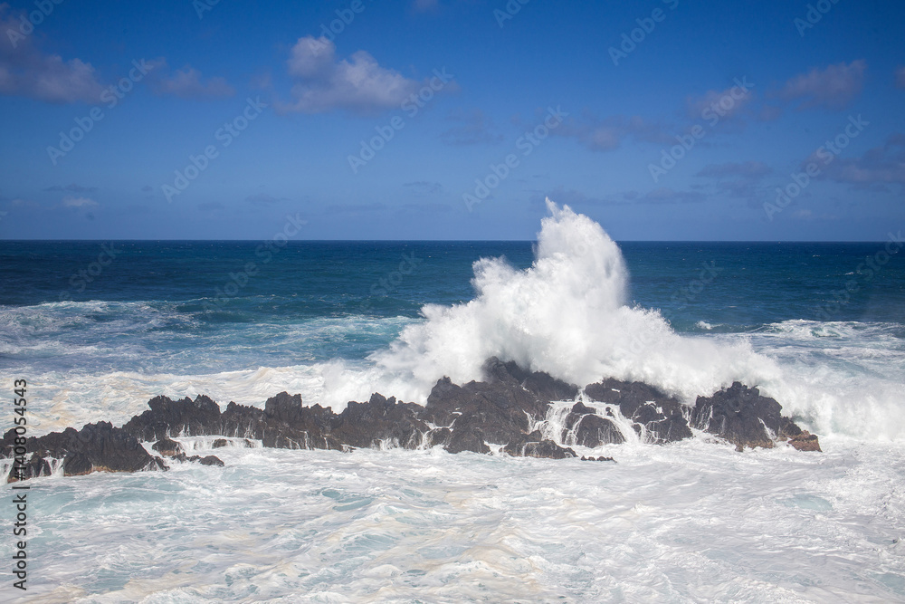 Natural ocean pools at Madeira Piscinas Naturais do Aquario set against dramatic coastal waves and blue skies
