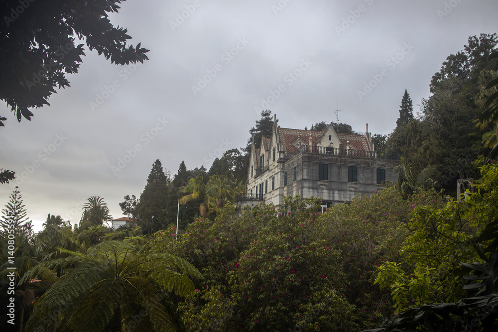 Stunning view of Monte Palace Garden featuring lush greenery and a historic building in Madeira