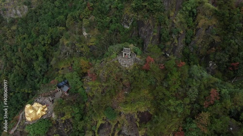 Aerial footage of towering mountains and temples perched on cliffs in Jiande Hangzhou Zhejiang China. High quality 4k footage photo
