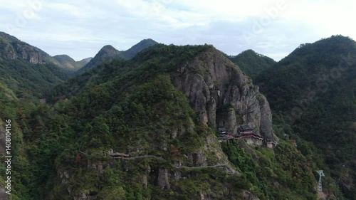 Aerial footage of towering mountains and temples perched on cliffs in Jiande Hangzhou Zhejiang China. High quality 4k footage photo