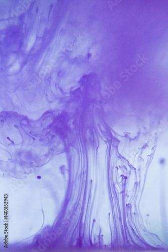 Delicate purple ink patterns dispersing in water