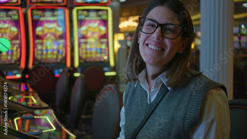 Photography Woman smiling indoors at a vibrant las vegas casino with colorful slot machines in the background, exuding energy and nightlife excitement