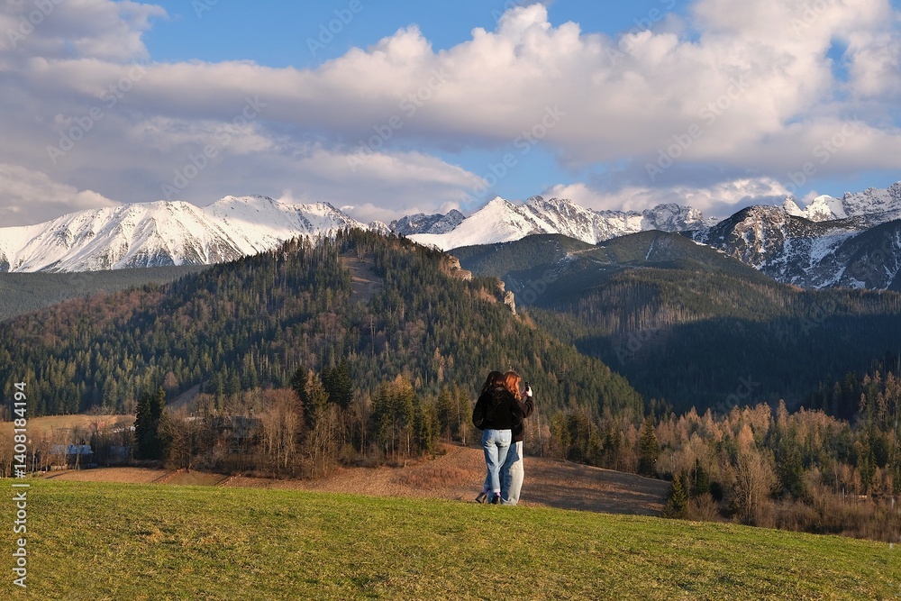 Silhouette of standing man in blue jacket on beautiful viewpoint with Tatras mountains on Antalowka, Zakopane, Poland