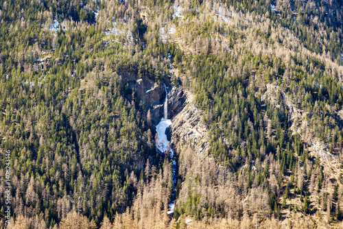 Obraz na płótnie High alpine waterfall in melting snow, Ötztal, Austria, 20 March 2025.. w salonie