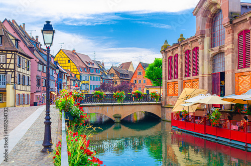 Little Venice la Petite Venise in old town Colmar city historic centre with old colorful houses and Covered market building on Quai Poissonnerie of river Lauch canal, Alsace Grand Est region, France
