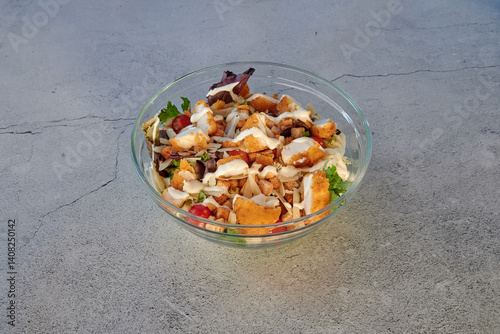 Obraz na płótnie A plate of food with chicken, bacon, and lettuce. The plate is white and the food is on a black surface w salonie