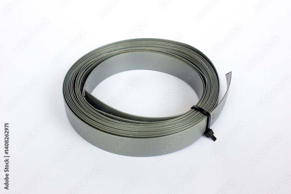 A roll of gray packaging straps isolated on white background. A roll of gray packaging straps isolated on white background.