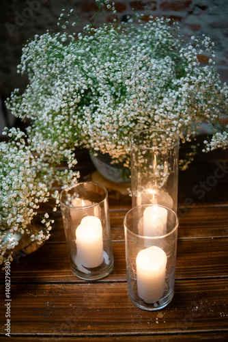 Candles and gypsophila on a rustic table