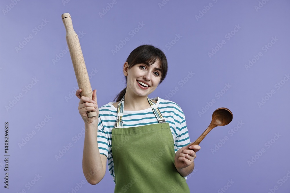 Woman with rolling pin and ladle on violet background