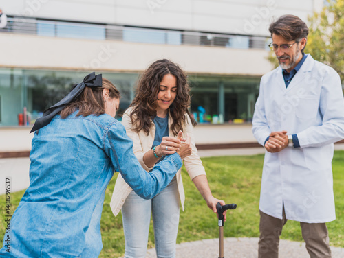 Doctor supervises young woman with cerebral palsy standing up - Doctor observes as caregiver helps young woman with cerebral palsy stand up - Concept of cerebral palsy.