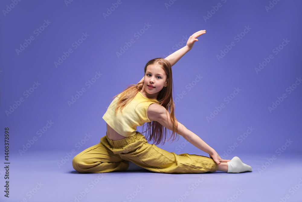 Girl in stylish clothes dancing on purple background