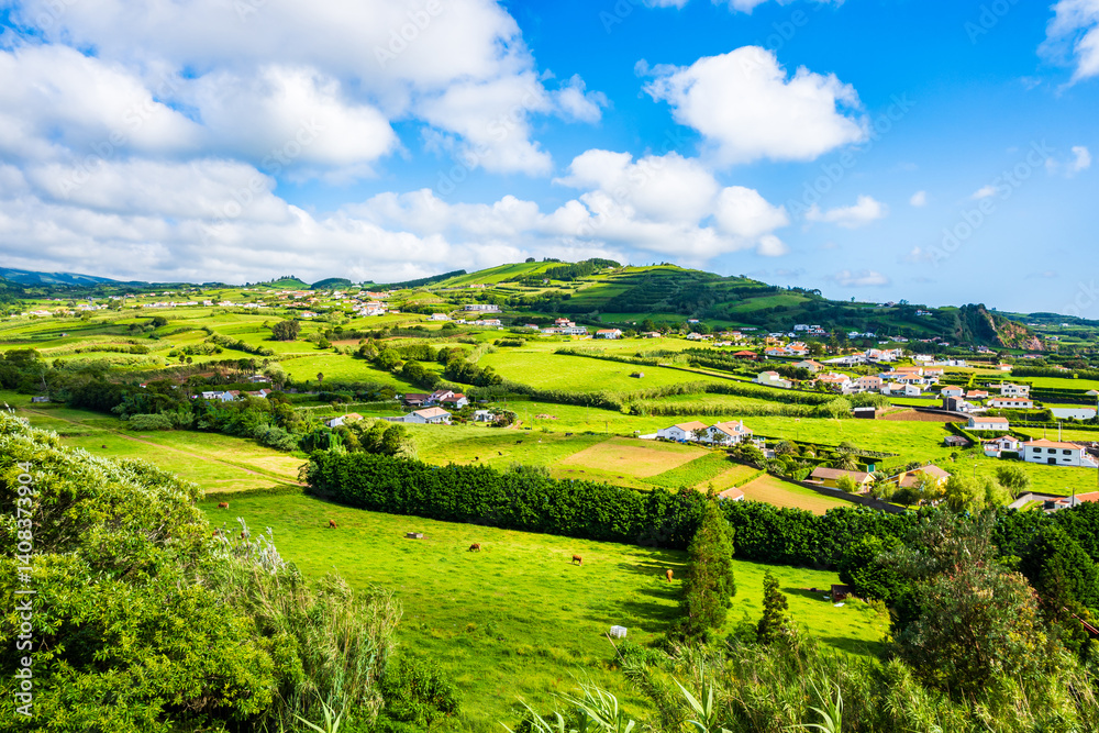 Green farming fields at Almoxarife bay with azure ocean water on coast of Faial island, Azores, Portugal