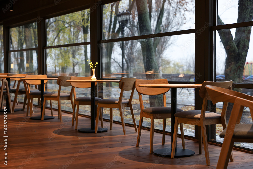 Stylish cafe with large windows and comfortable furniture. Interior design Stylish cafe with large windows and comfortable furniture. Interior design