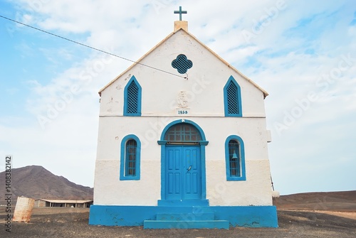 small white and blue evangelical church rises with quiet dignity. Surrounded by arid terrain, it stands as a beacon of faith, resilience, and spiritual hope in the vast African solitude. 