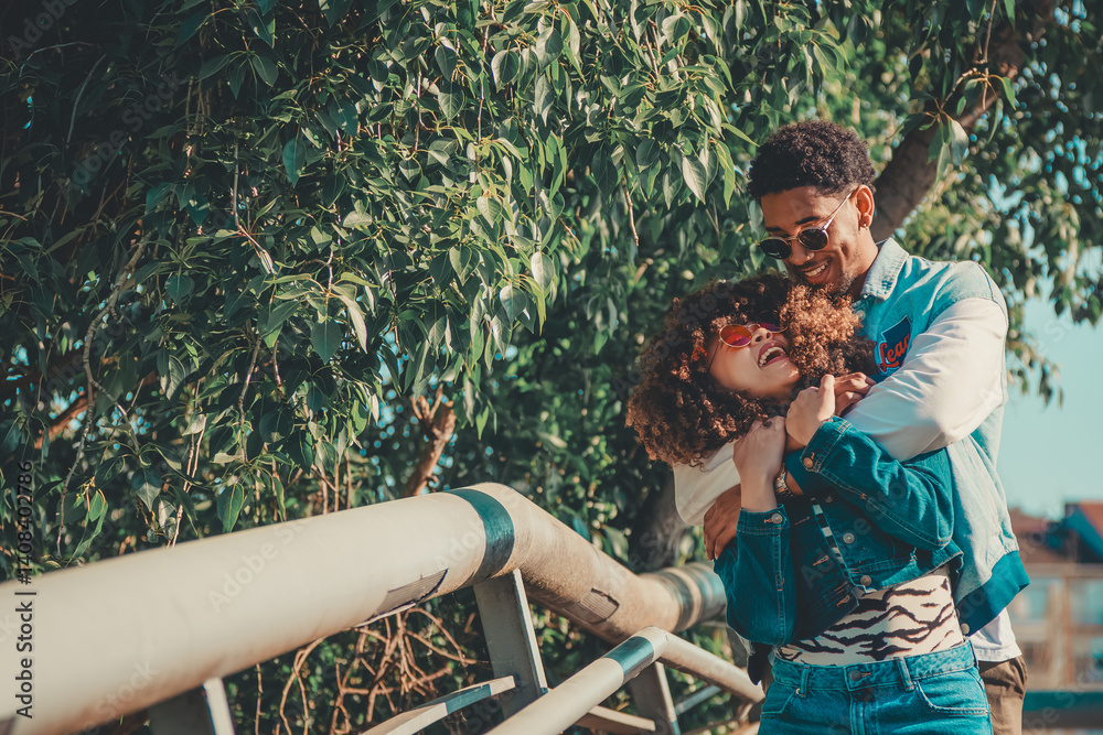 romantic latin couple hugging happily outdoors